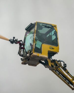 Close-up view of an aerial firefighting machine spraying water during a safety drill.